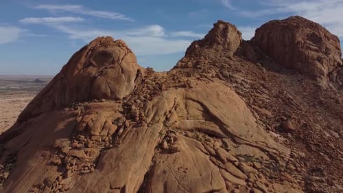 Big mountain on the foreground with stunning view on the desert behind it