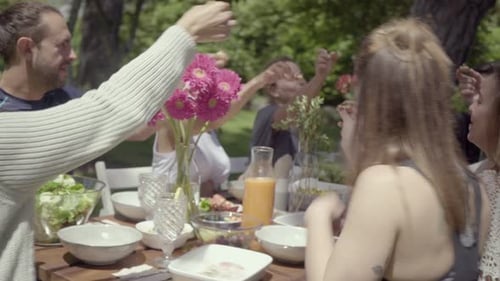 Friends Sharing a Meal at Garden Table