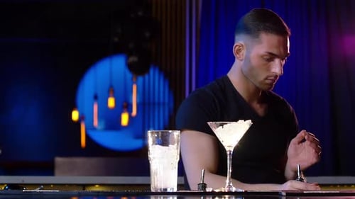 Slow Motion Clip of Bartender Pouring Drinks on Empty Glasses By the Bar