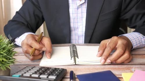 Close Up of Man Hand Writing on Notepad