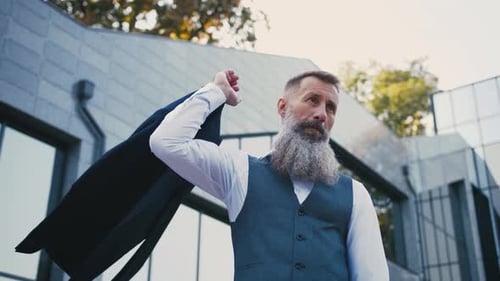Portrait of Handsome Bearded Mature Man in Suit Outdoors on Modern Building Background During Sunny