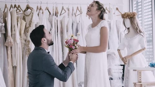 Loving Couple in Bridal Shop with Flowers