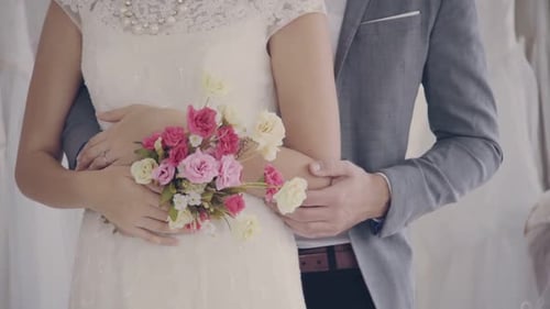 Romantic Couple Embrace at Wedding Dress Shop