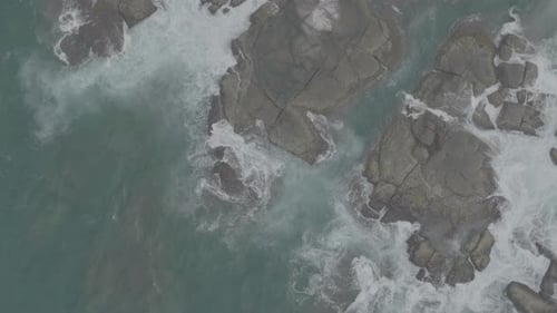 Waves Crash Against Rocks in the Ocean