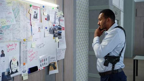Detective Inspecting Evidence Board in Office