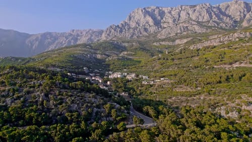 Drone Aerial Flight Across the Small Town in the Mountains