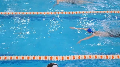 Young Competitors Swim Race in Breaststroke in Modern Pool
