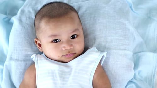 Adorable Baby Lying on a Blue Blanket
