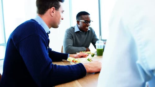Executives having breakfast together in the cafeteria