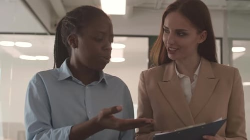 Two Businesswomen Going along Office