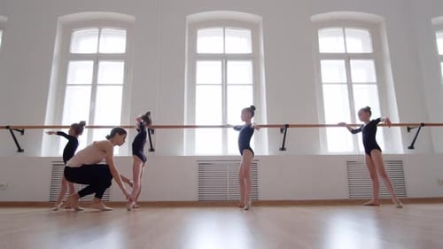 Ballerina Teaching Students in Ballet School