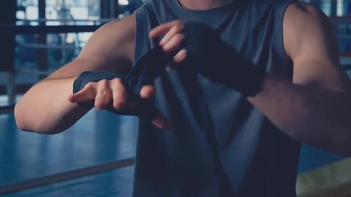 Boxer Wrapping Hands Before Training in Gym