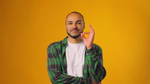 Man Smiling and Showing Okay Hand Gesture