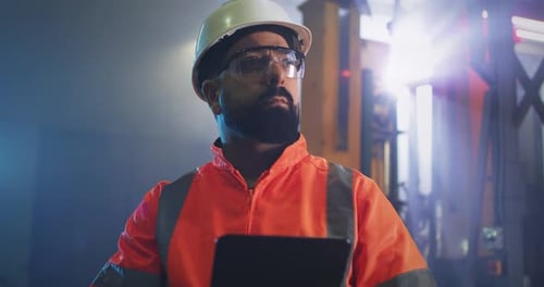 Male Engineer Using Tablet on Factory
