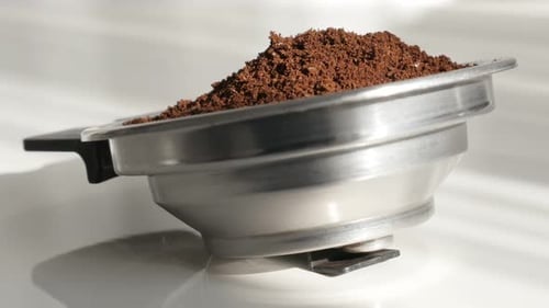 Espresso Grounds Ready in a Metal Portafilter