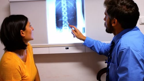 Doctor Showing Spinal X-ray to Patient