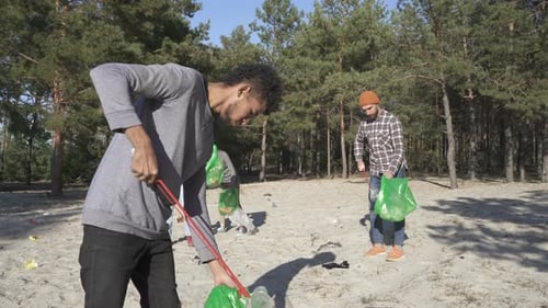 Volunteers Cleaning Up Trash in Forest Environment