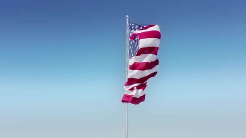 Waving American Flag Against a Bright Blue Sky