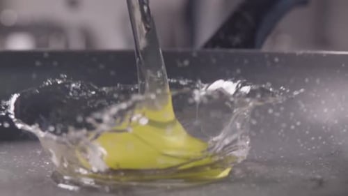 Egg Splashing As Water Being Poured Over