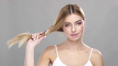 Attractive Blonde Woman Smiling and Posing with Hair