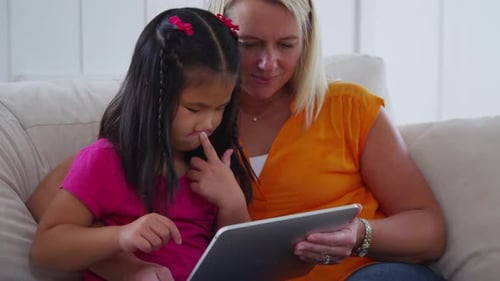 Mother and daughter using digital tablet. Shot on RED EPIC for high quality 4K, UHD, Ultra HD resolu