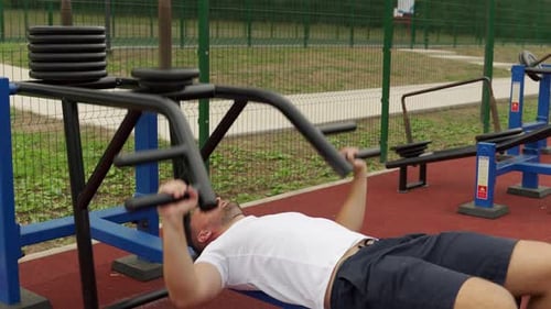 Man Working Out on Weight Bench Outdoors