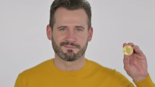 Portrait of Middle Aged Man Holding Bitcoin Crypto Currency