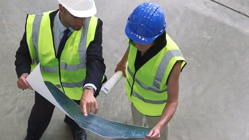 Architects Reviewing Plans at Construction Site