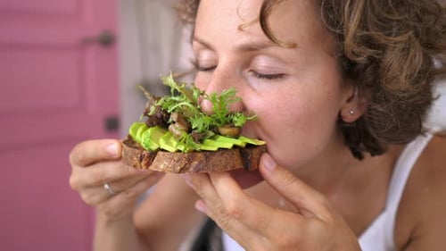 Woman Eats Avocado Toast for Healthy Brunch