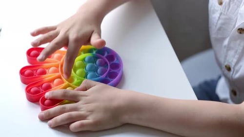 Child Play with Pop It Sensory Toy