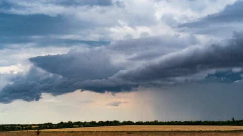 Dramatic Storm Clouds Rolling Over Harvested Field