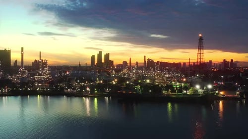 4k aerial view drone of refinery oil petroleum production factory with river reflecting