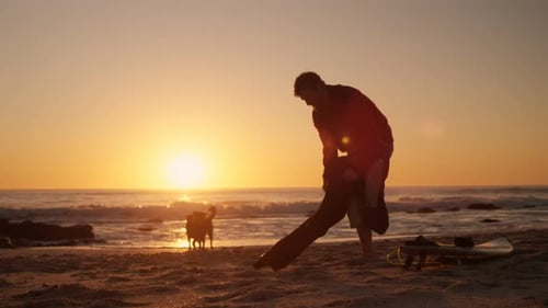 Man wearing wetsuit in the beach