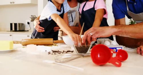 Happy family preparing cookies in kitchen