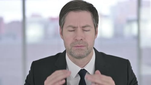 Man Massaging Temples Due to a Headache