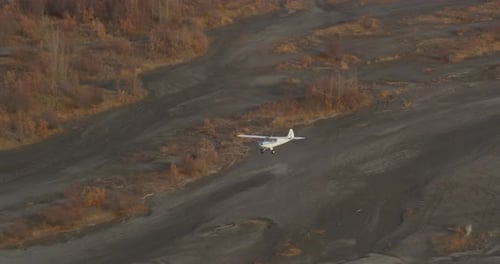 Small Plane Taking Off Near Rural Lake