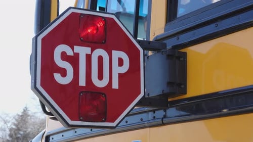 School Bus Stop Paddle Being Turned Off