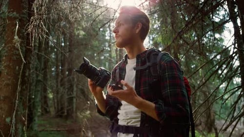 Photographer with Photo Camera Standing in Forest