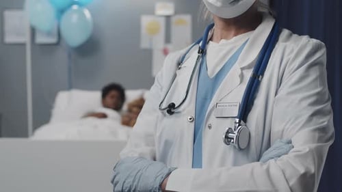 Female Doctor in Mask Posing in Ward