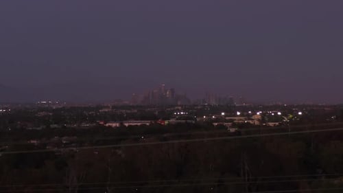 AERIAL: Wide View of Downtown Los Angeles, California Skyline From Culver City at Dusk, Night with