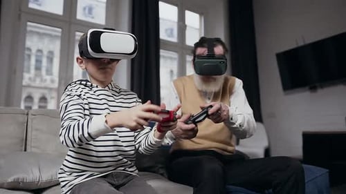 Boy and Senior Man Playing VR Video Games