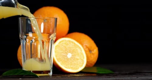 Pouring Fresh Orange Juice into Glass