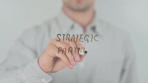 Writing Strategic Partners with Marker on Transparent Surface