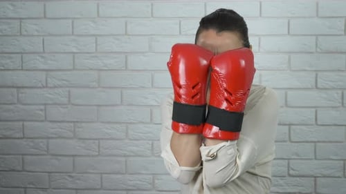 Woman with Boxing Gloves Punches and Smiles