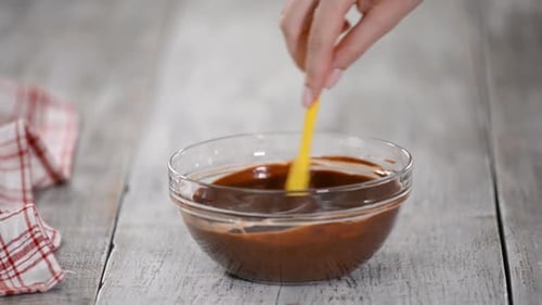 Stirring Melted Chocolate in Glass Bowl with Spatula