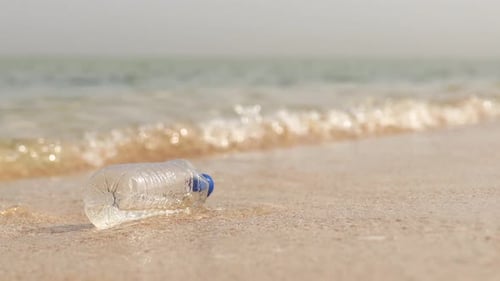 Polyethylene Bag and Plastic Bottle on Sand at Beach Problem of Pollution