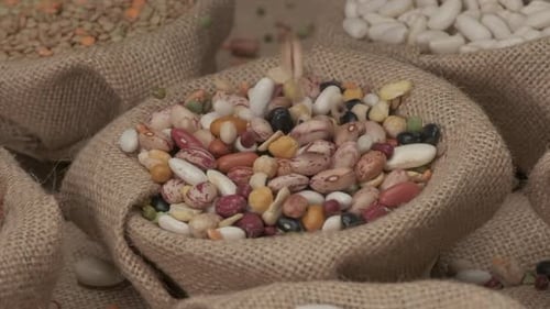 Beans Pouring into Burlap Sack in Rural Setting
