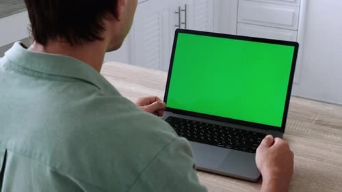 Closeup Back View Shoot of Young Business Man Having a Video Call on the Laptop with Green Chroma