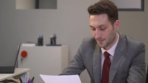 Businessman receiving a document and talking