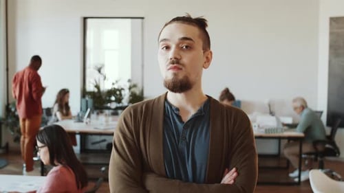 Portrait of Joyous Male Worker in Modern Open Space Office